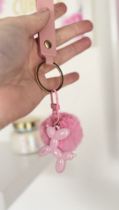 Llavero perro globo pompon rosa